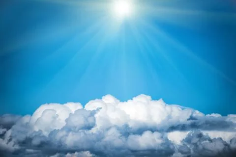 White clouds and bright sun on the blue sky Stock Photos