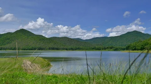White clouds and mountain backdrops and lakes Stock Footage 91635983