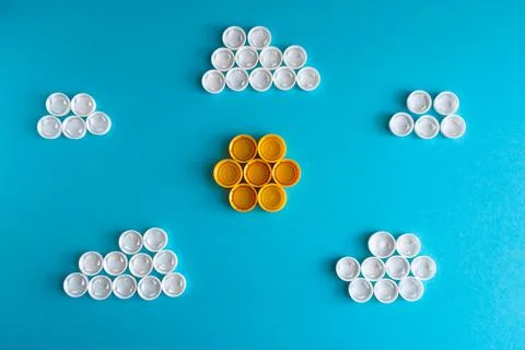 White clouds and the Sun made of plastic bottle caps Stock Photos