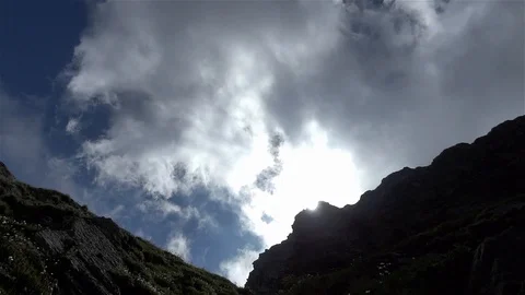 White clouds and thin passing in speed over the mountain crests Stock Footage 96711785