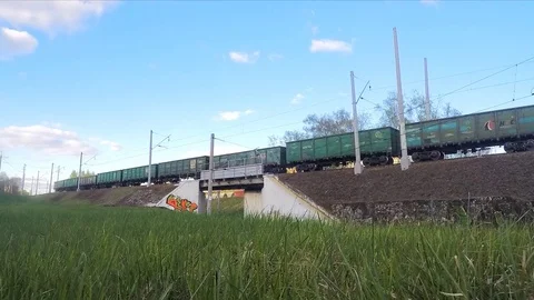 White clouds and trains on rails in the spring timelapse Stock Footage 82987961
