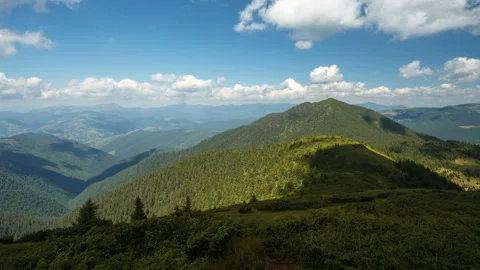White clouds are flying over mountains in the sunny day at summer. Carpathians Stock Footage 132173492