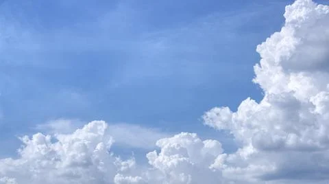 White clouds are located on the right and bottom of the image, and on the lef Stock Photos