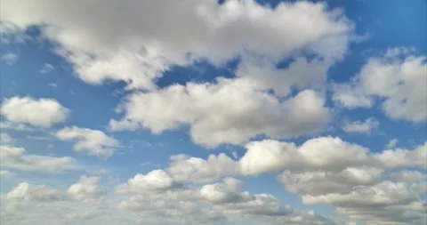 White clouds are passing under blue sky in relaxing time lapse clip Stock Footage 131295931