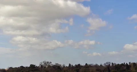 White clouds are passing under blue sky in relaxing timelapse clip Stock Footage 131299135