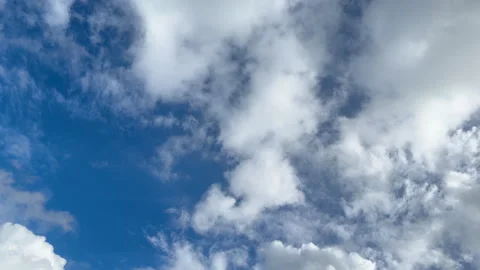 White clouds are rapidly floating across the blue sky. Stock Footage 302386098