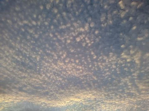 White clouds are small spots on the blue sky. Photos