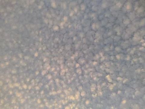 White clouds are small spots on the blue sky. Photos