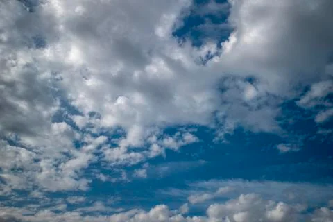White clouds on a background of blue sky. Stock Photos