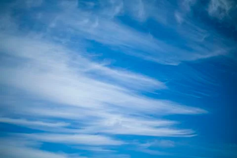White clouds on a background of blue sky. Stock Photos