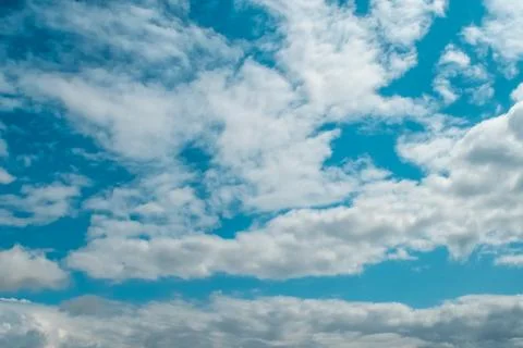 White clouds on background of blue sky on day. Stock Photos