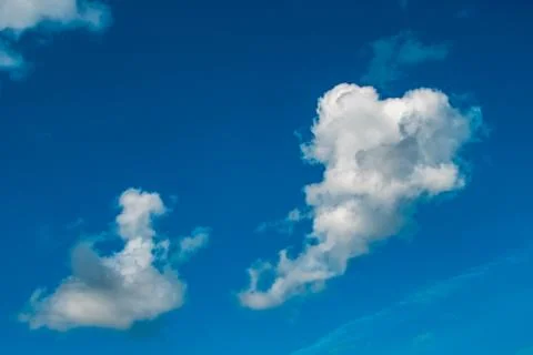 White clouds on background of blue sky on day. Stock Photos