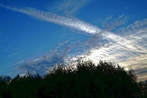 White clouds on a background sunset blue sky Stock Photos