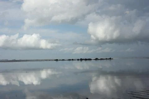 White Clouds on the beach Stock Photos