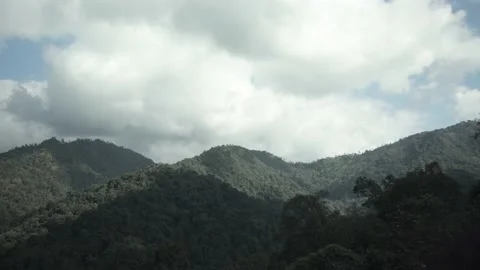 White clouds blocked sunlight, creating shadows on the mountains in a wide area. Stock Footage 174640052