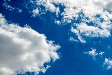 White clouds on a blue background. Horizontal photography. Stock Photos