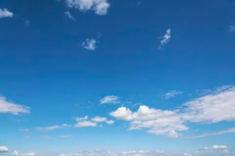White clouds on the blue clear sky. Stock Photos