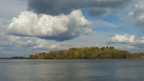 White clouds on the blue sky are reflected in the river Stock Footage 83444971