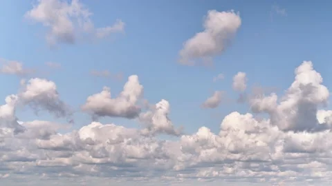 White clouds in the blue sky are floating forward, time-lapse. Clouds float towa Stock Footage 159565858