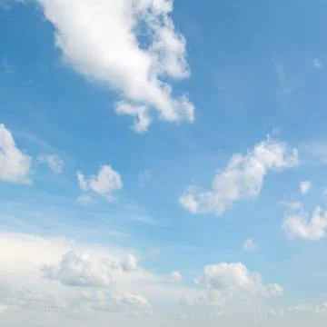 White clouds on a blue sky background Stock Photos