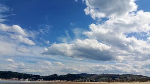 White clouds on the blue sky background over Spanish mountains and river Stock Photos