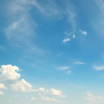 White clouds on a blue sky background Stock Photos