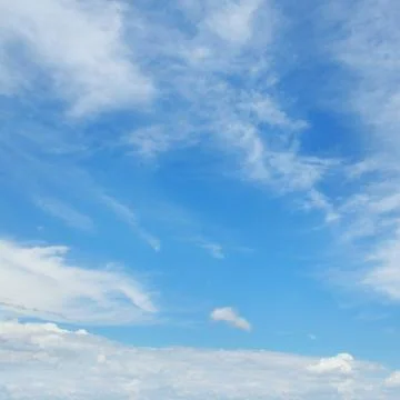 White clouds on a blue sky background Stock Photos