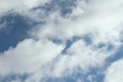 White clouds on a blue sky. Background for text and design Stock Photos