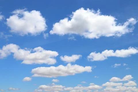White clouds blue sky background. White fluffly clouds texture. Stock Photos
