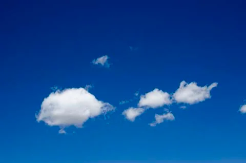 White clouds on a blue sky. Background. Stock Photos