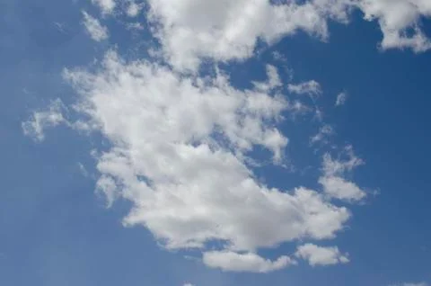White clouds on a blue sky. Background. Stock Photos
