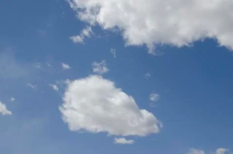 White clouds on a blue sky. Background. Stock Photos