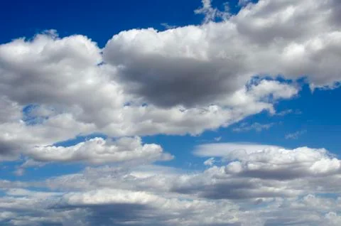 White clouds on a blue sky. Background. Stock Photos