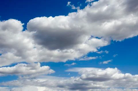 White clouds on a blue sky. Background. Stock Photos