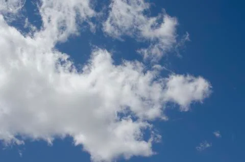 White clouds on a blue sky. Background. Stock Photos