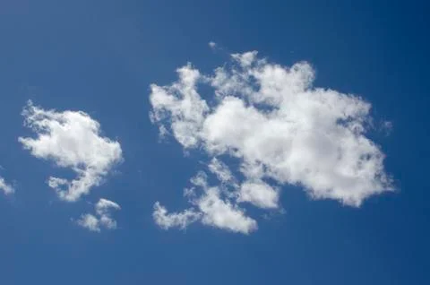 White clouds on a blue sky. Background. Stock Photos