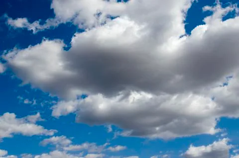 White clouds on a blue sky. Background. Stock Photos