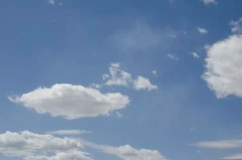 White clouds on a blue sky. Background. Stock Photos
