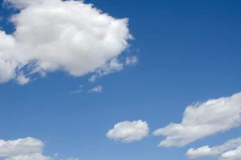 White clouds on a blue sky. Background. Stock Photos