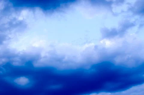 White clouds on a blue sky. Background. Stock Photos