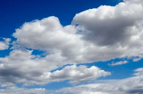 White clouds on a blue sky. Background. Stock Photos