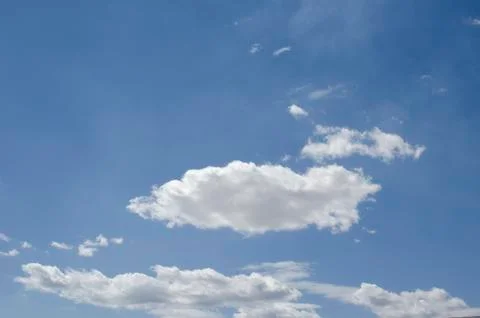 White clouds on a blue sky. Background. Stock Photos