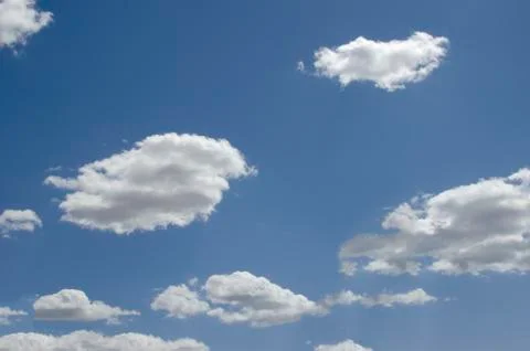 White clouds on a blue sky. Background. Stock Photos