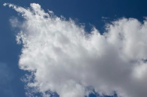 White clouds on a blue sky. Background. Stock Photos