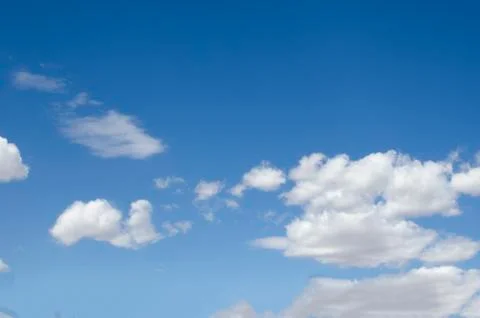 White clouds on a blue sky. Background. Stock Photos