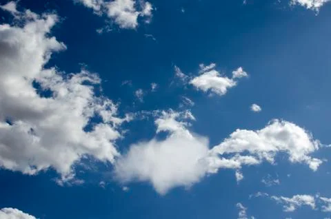 White clouds on a blue sky. Background. Stock Photos
