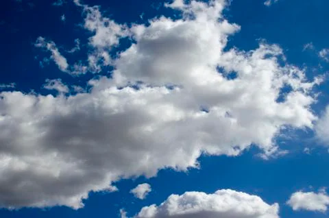 White clouds on a blue sky. Background. Stock Photos