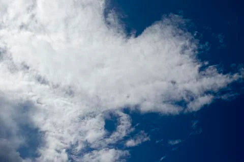 White clouds on a blue sky. Background. Stock Photos