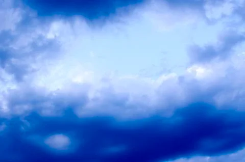 White clouds on a blue sky. Background. Stock Photos