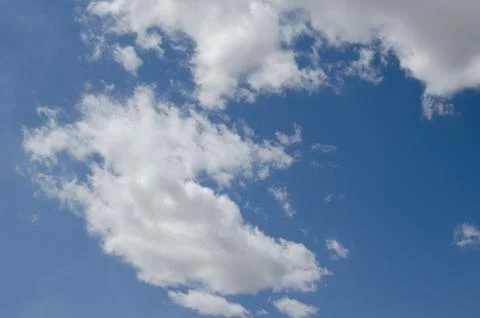 White clouds on a blue sky. Background. Stock Photos
